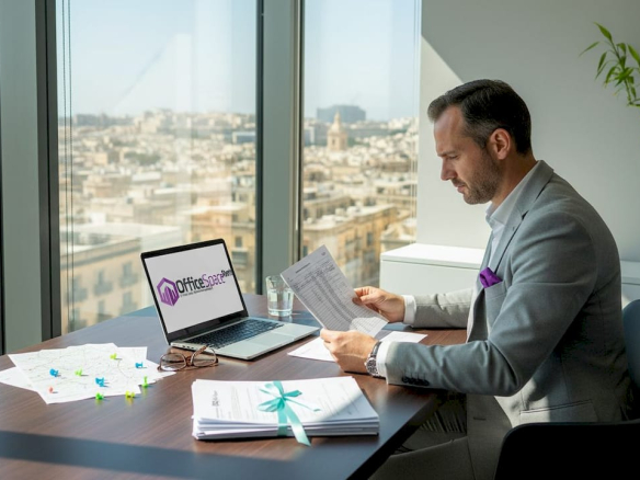Finance manager reviews tax documents in Malta office