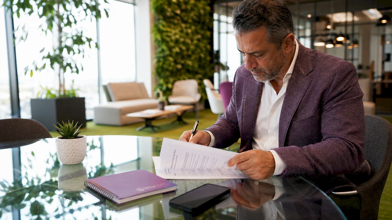 Landlord reviewing lease agreement in office