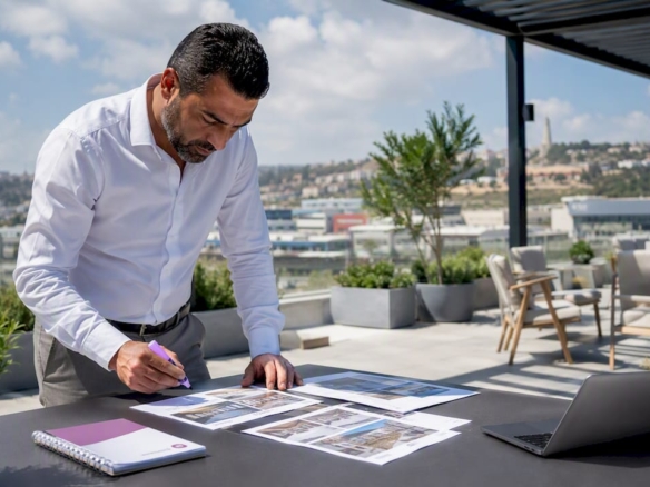 Agent reviewing Malta office space listings at desk