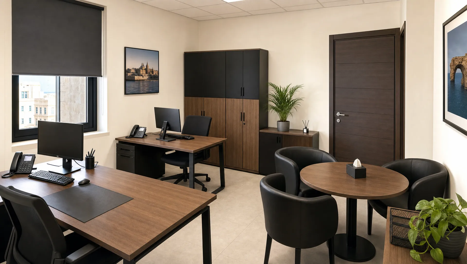 A compact private office in Malta with two desks, storage cabinets, a closed door and a small meeting area for confidential calls.