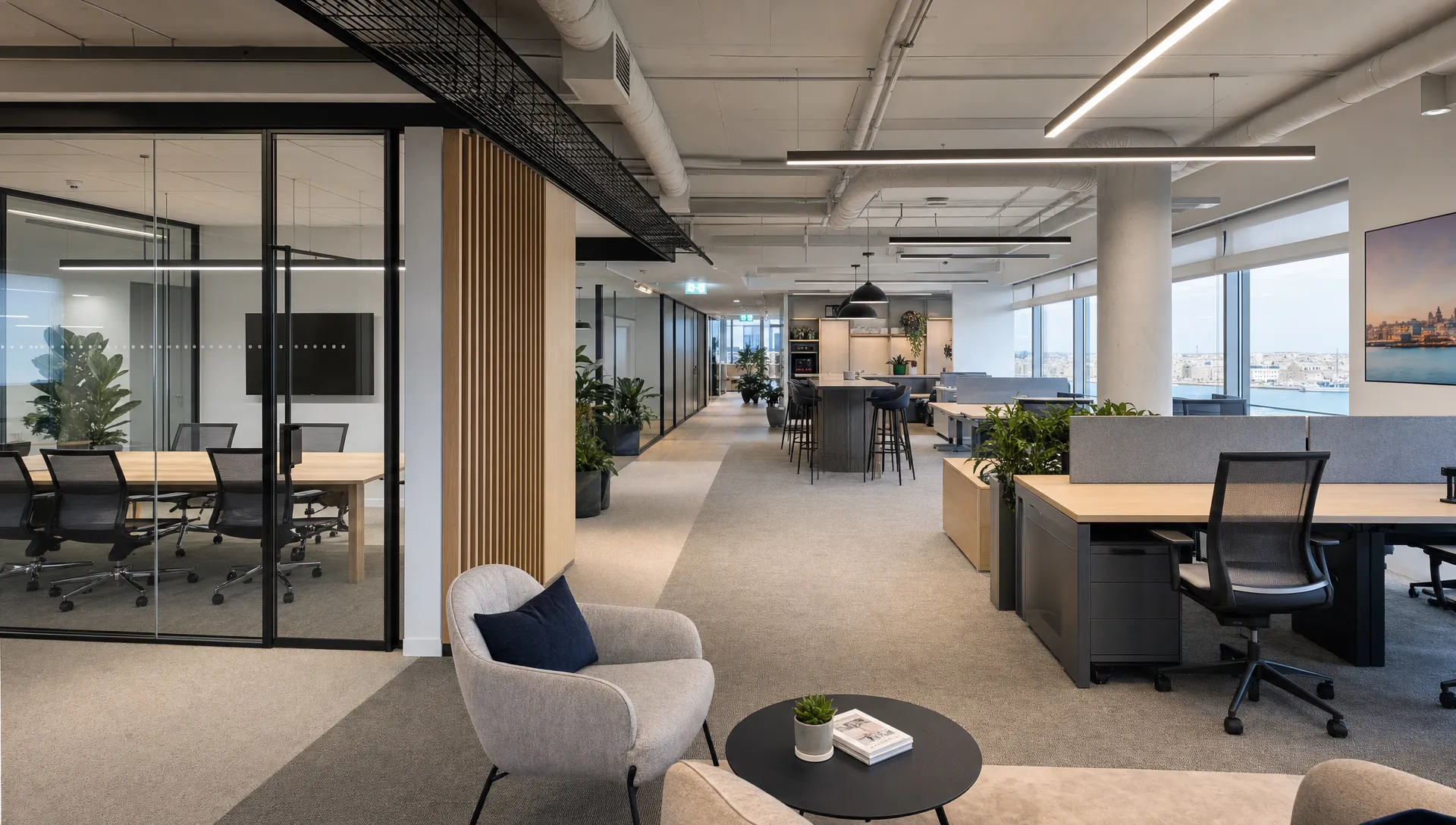 A Malta office interior shows private desks, meeting rooms and collaboration areas arranged for hybrid teams.